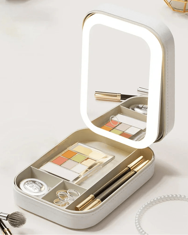 White luxury LED makeup case with eyeshadow palette, brushes, and jewelry organizer.